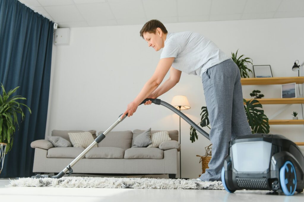 Cleaning concept. woman cleaning carpet with vacuum cleaner.